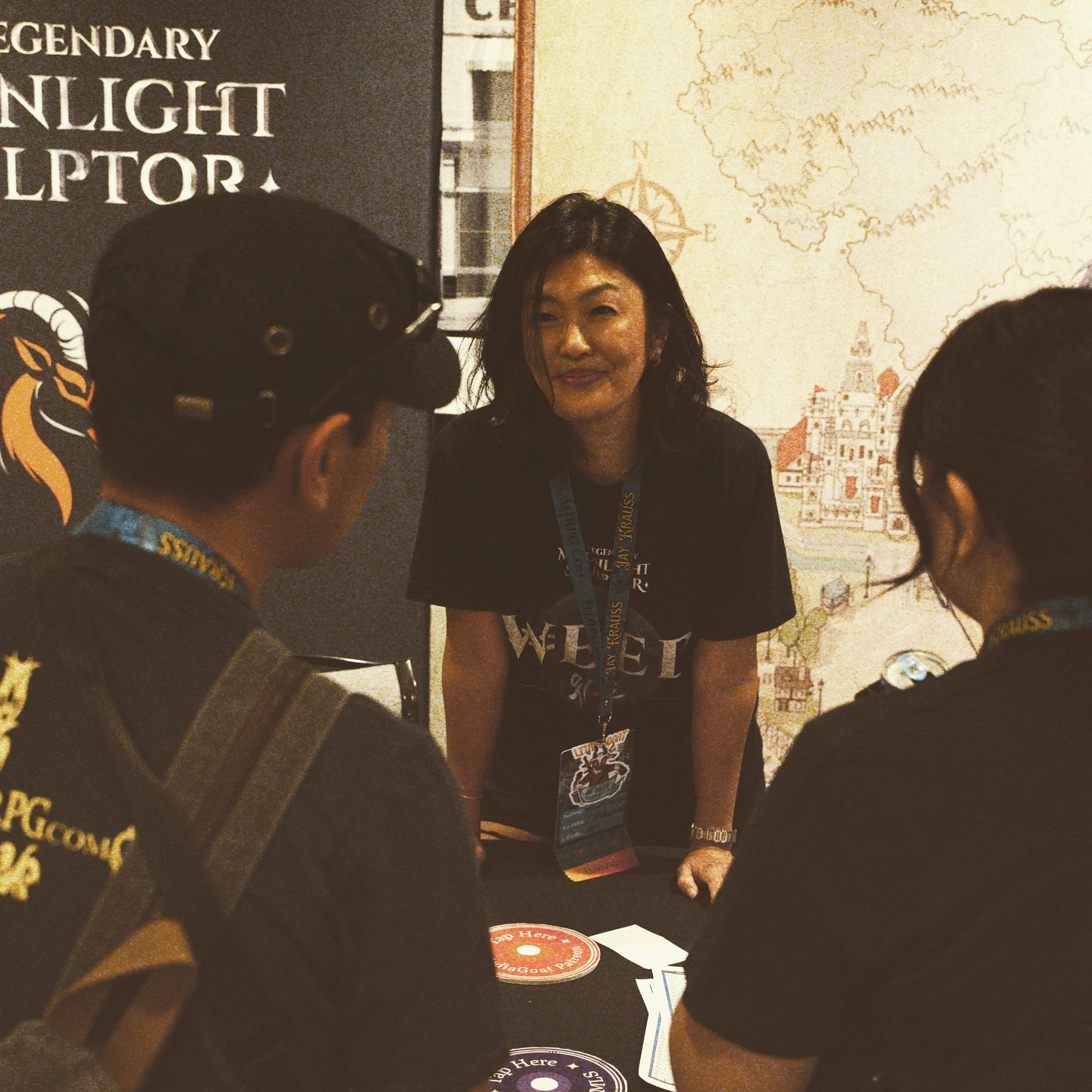 Photo of three people with Media Goat's Legendary Moonlight Sculptor stand